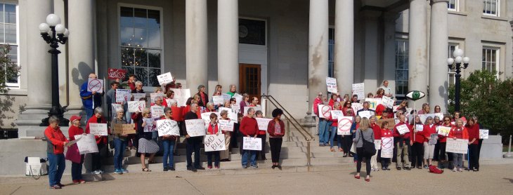 Voucher opponents on the State House steps